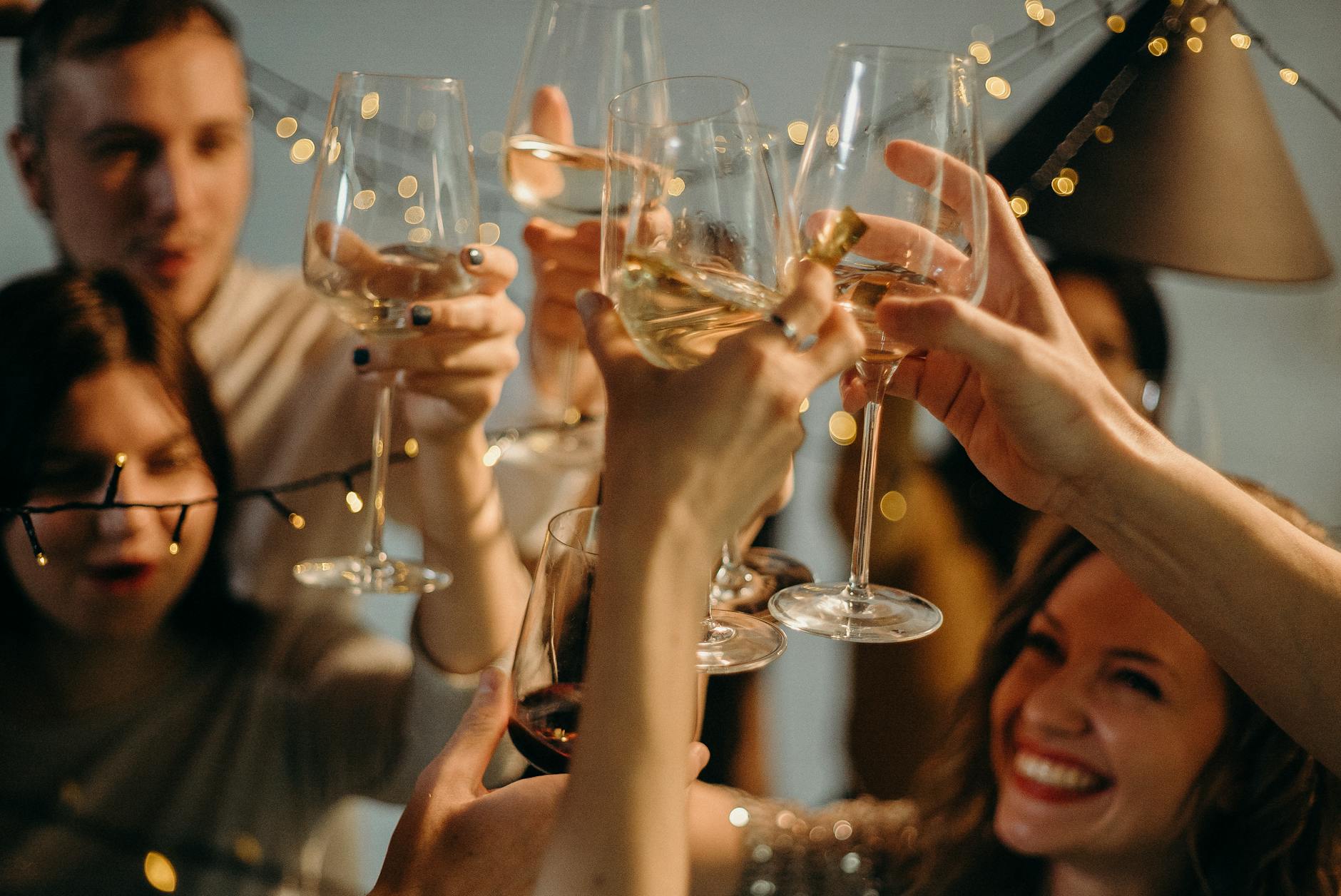 selective focus photography of several people cheering wine glasses
