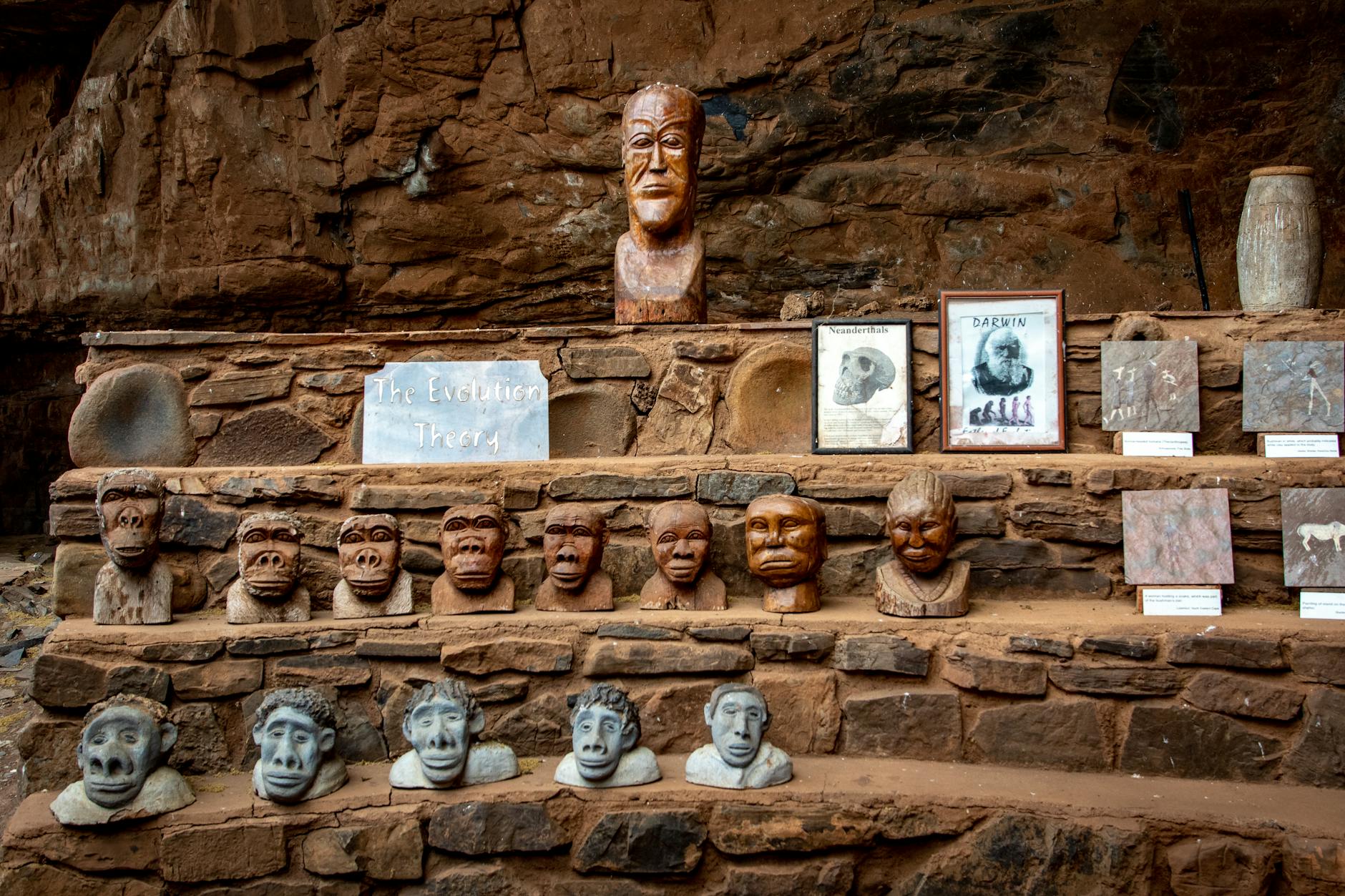 head carvings on a clay and stone stairs